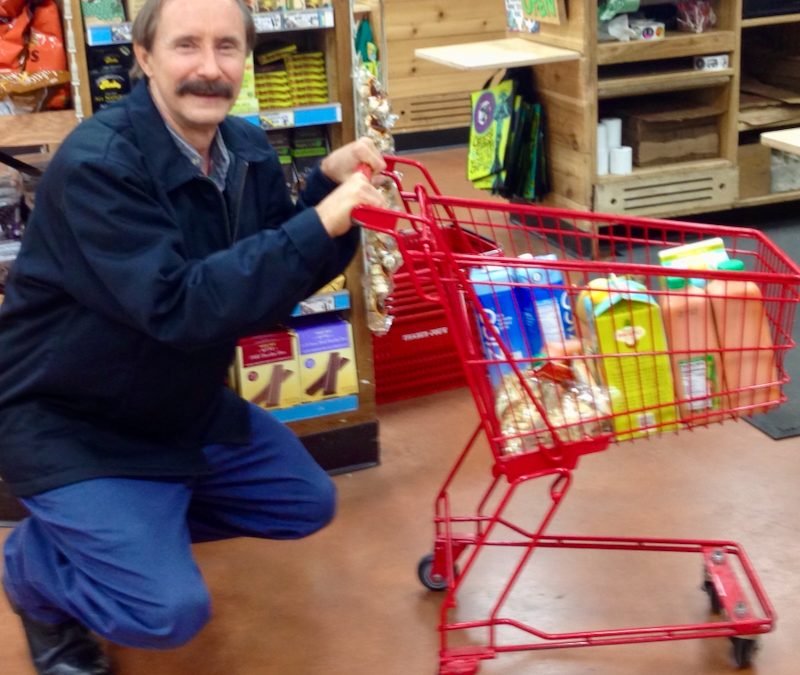 Paulie Zink shopping with a kiddie cart in the grocery store