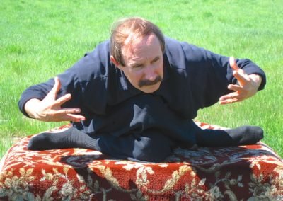 Yin Yoga Poses Paulie Zink demonstrating Cross Legged Frog (Shoelace) Yin yoga pose